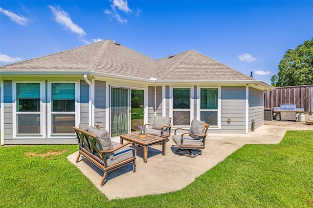 back of house featuring a yard, a shingled roof, outdoor lounge area, a patio area, and fence