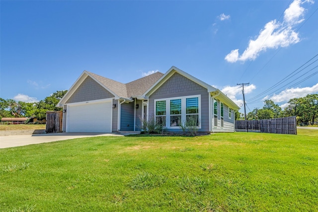 view of front of house featuring a front yard, concrete driveway, fence, and an attached garage