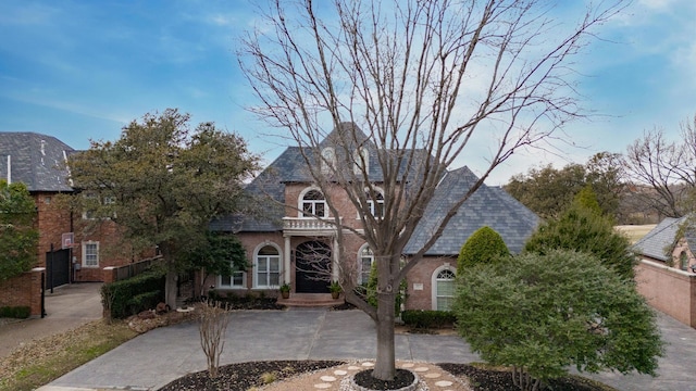 view of front of property featuring driveway and brick siding