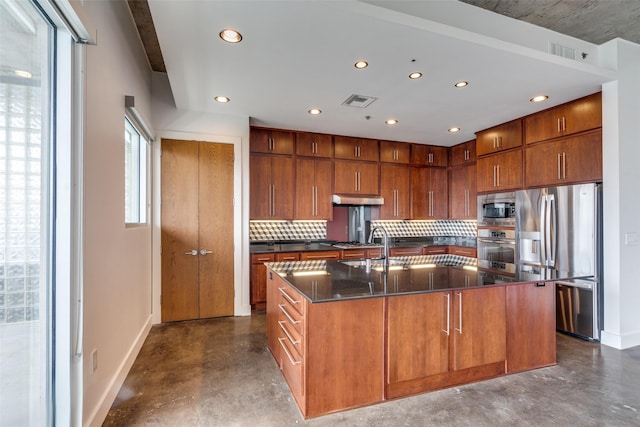 kitchen featuring under cabinet range hood, visible vents, concrete floors, and appliances with stainless steel finishes