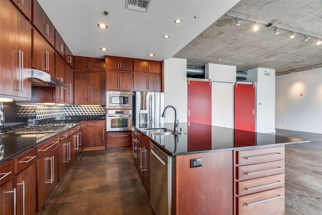 kitchen with visible vents, appliances with stainless steel finishes, concrete flooring, under cabinet range hood, and a sink