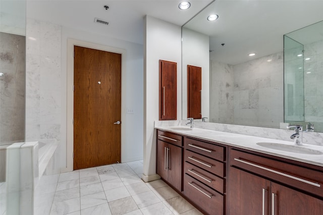 bathroom featuring double vanity, a bathing tub, and a sink