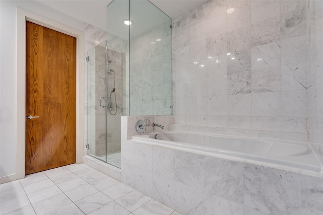 full bathroom with a shower stall, a bath, and tile walls