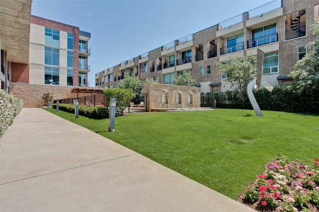 view of property's community with a residential view and a yard