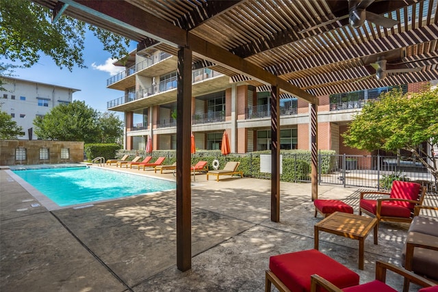 pool with fence, a patio, and a pergola