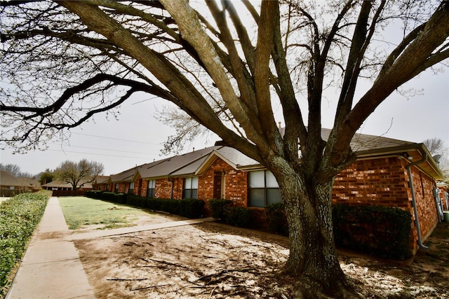 view of side of property with brick siding