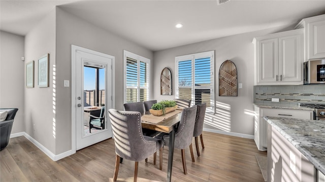 dining room with light wood-type flooring, visible vents, baseboards, and recessed lighting