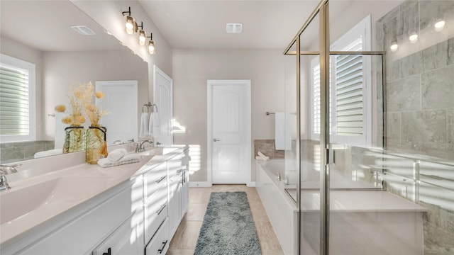 bathroom featuring a garden tub, double vanity, a stall shower, and a sink