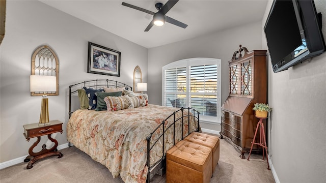 carpeted bedroom with a ceiling fan and baseboards