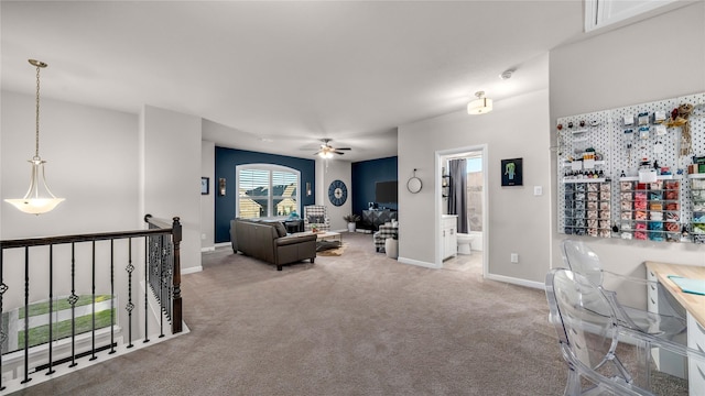 carpeted living area featuring ceiling fan and baseboards