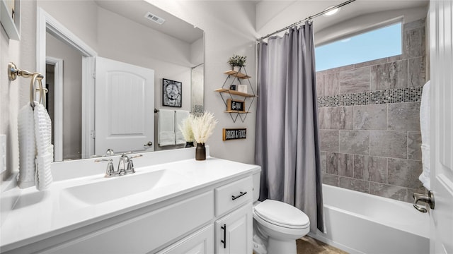 bathroom featuring shower / bath combination with curtain, visible vents, vanity, and toilet