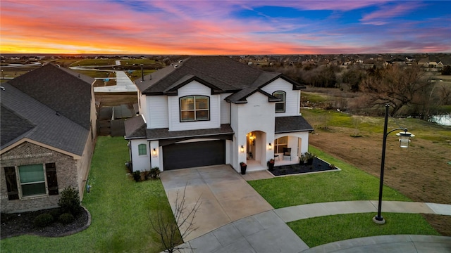 french provincial home featuring concrete driveway, a shingled roof, a lawn, and an attached garage