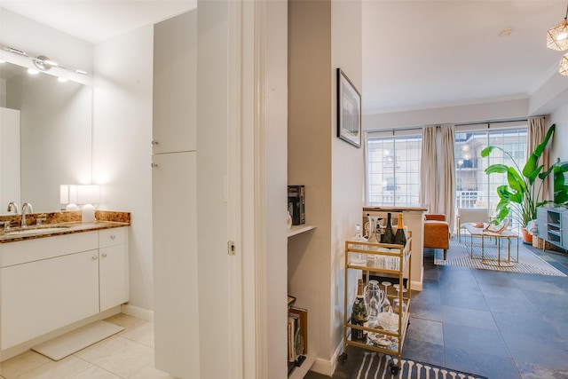 bathroom featuring baseboards and vanity