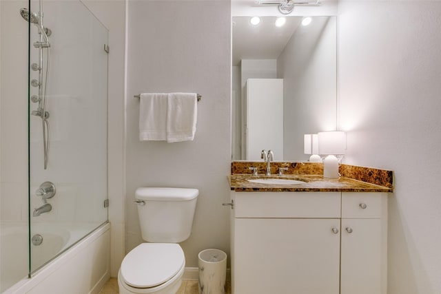 full bathroom with baseboards, vanity, toilet, and washtub / shower combination