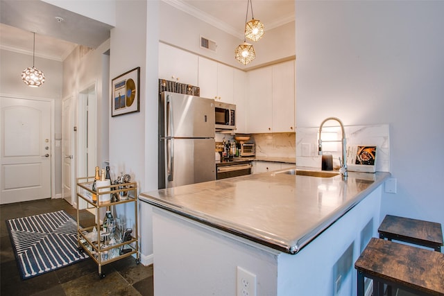 kitchen featuring visible vents, a sink, stainless steel countertops, appliances with stainless steel finishes, and a peninsula