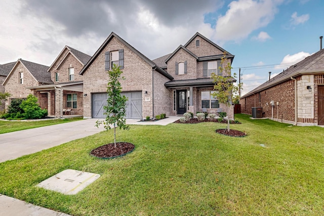 view of front of home featuring central air condition unit, a garage, brick siding, concrete driveway, and a front yard