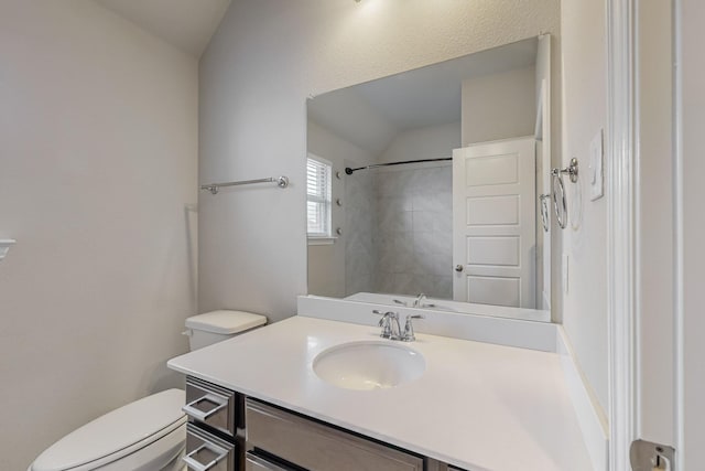 bathroom featuring toilet, walk in shower, and vanity