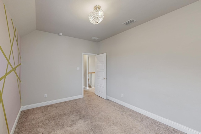 carpeted empty room featuring visible vents and baseboards