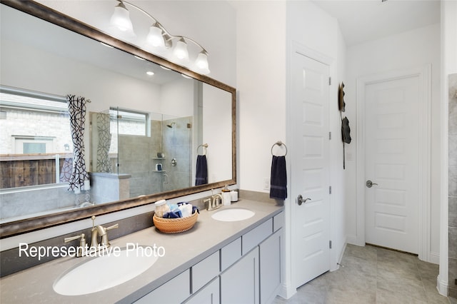 full bathroom featuring double vanity, a shower stall, a sink, and tile patterned floors