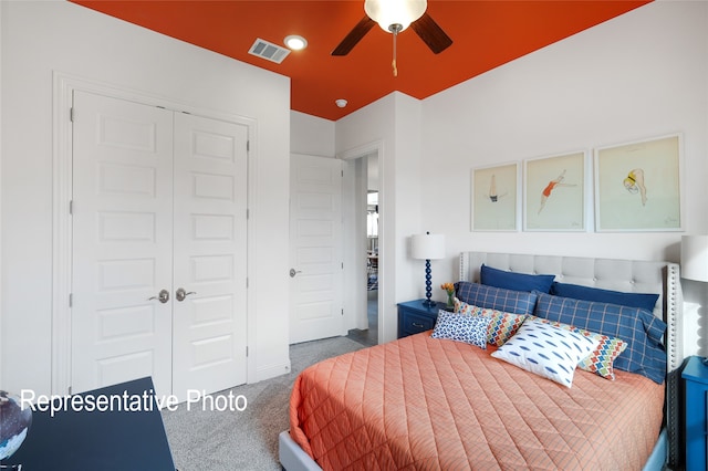 bedroom featuring carpet floors, ceiling fan, visible vents, and a closet