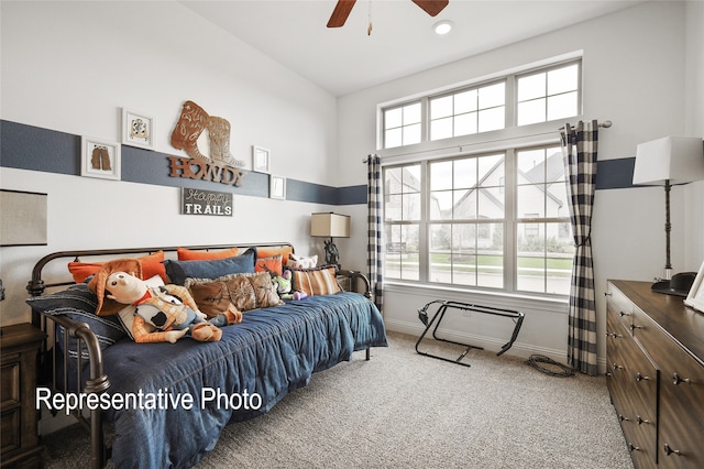 bedroom featuring lofted ceiling, a ceiling fan, baseboards, and carpet flooring