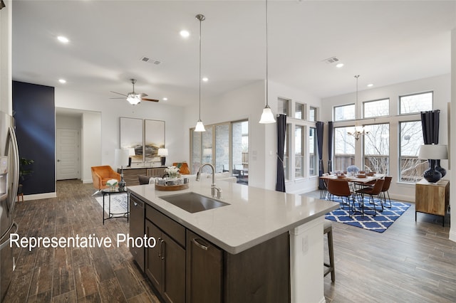 kitchen with light countertops, dark wood-style flooring, visible vents, and a sink