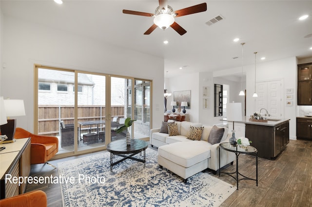 living area featuring dark wood-style floors, a ceiling fan, visible vents, and recessed lighting