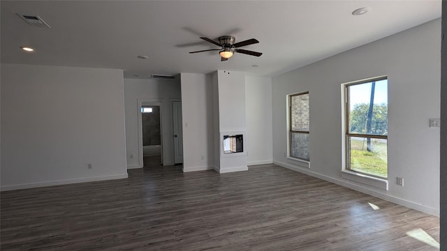 spare room featuring dark wood-type flooring, recessed lighting, visible vents, and baseboards