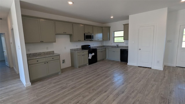 kitchen featuring gray cabinetry, light wood-style flooring, and black appliances