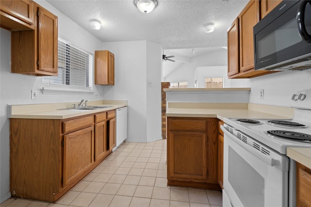 kitchen with light countertops, white appliances, a sink, and a ceiling fan