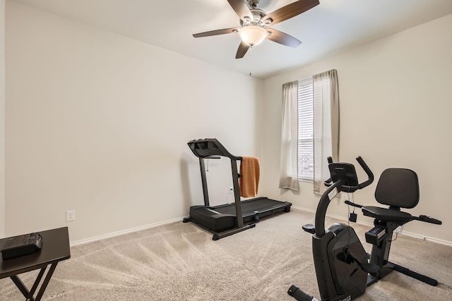 exercise area featuring a ceiling fan, carpet flooring, and baseboards