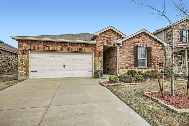 view of front facade with driveway, stone siding, roof with shingles, an attached garage, and brick siding