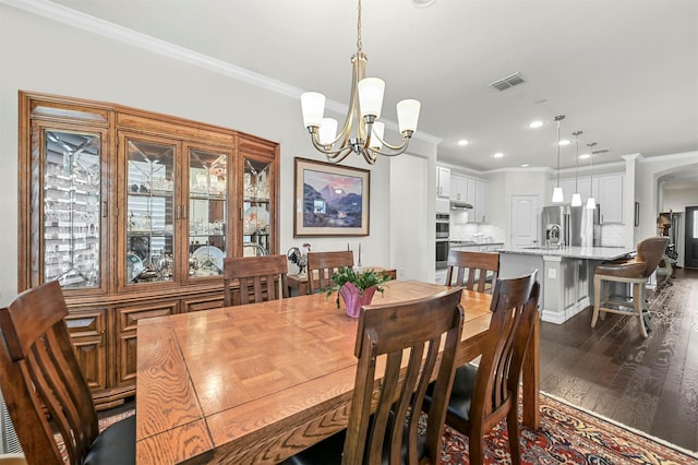 dining room featuring crown molding, recessed lighting, visible vents, an inviting chandelier, and dark wood-type flooring