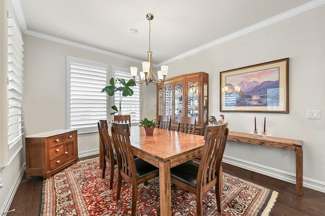 dining space featuring dark wood-style floors, a chandelier, ornamental molding, and baseboards