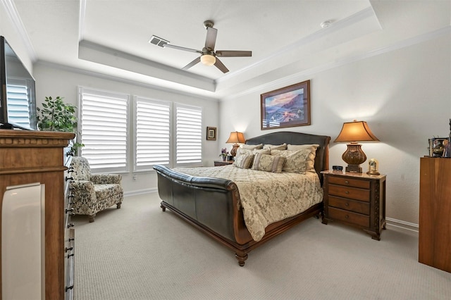 bedroom featuring light carpet, a tray ceiling, ornamental molding, and visible vents