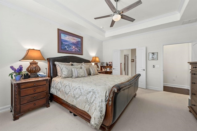 bedroom featuring light carpet, baseboards, a raised ceiling, and crown molding