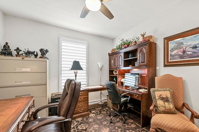 office area with ceiling fan and baseboards