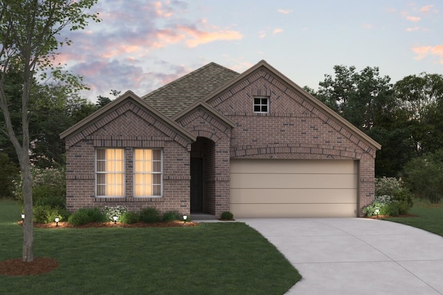 view of front of house featuring brick siding, a shingled roof, concrete driveway, an attached garage, and a front yard