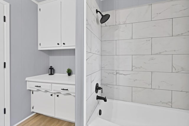 bathroom featuring wood finished floors and shower / washtub combination