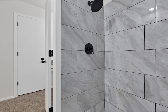 interior details featuring carpet and tiled shower