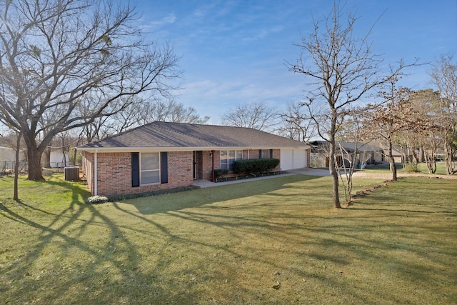 single story home with central air condition unit, a front lawn, roof with shingles, a garage, and brick siding