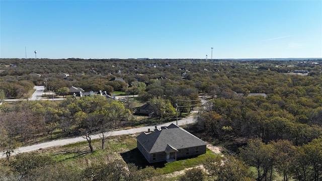 birds eye view of property featuring a wooded view