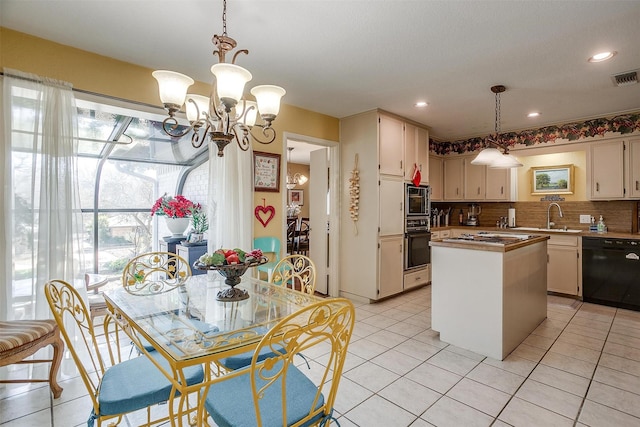 kitchen with tasteful backsplash, visible vents, a center island, black appliances, and light tile patterned flooring