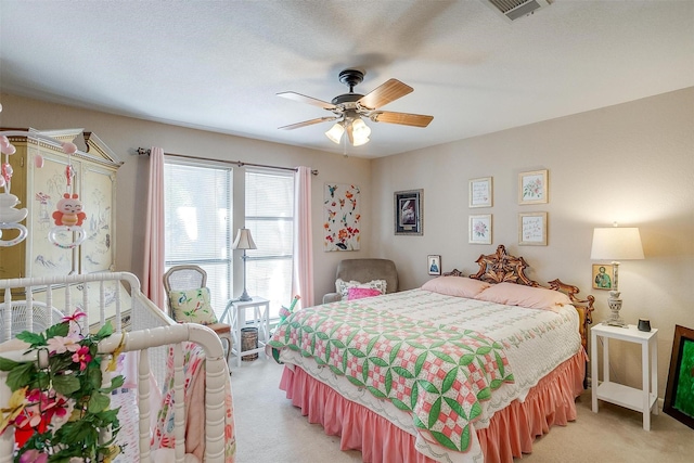 bedroom featuring light carpet, ceiling fan, and visible vents