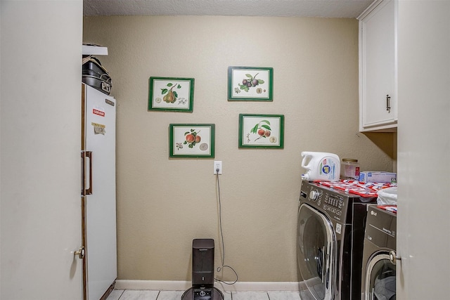 clothes washing area featuring washer / clothes dryer, cabinet space, baseboards, and light tile patterned floors