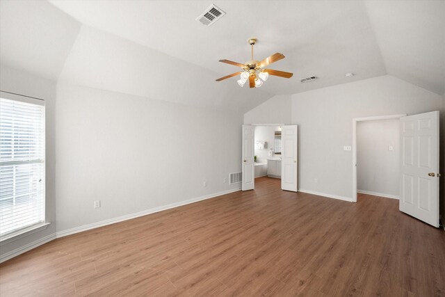 bedroom with a ceiling fan, multiple windows, baseboards, and wood finished floors