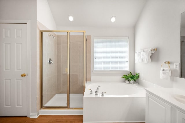 full bath with wood finished floors, a garden tub, vaulted ceiling, vanity, and a shower stall