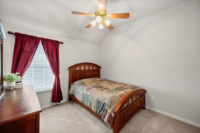 bedroom with carpet floors, ceiling fan, baseboards, and lofted ceiling