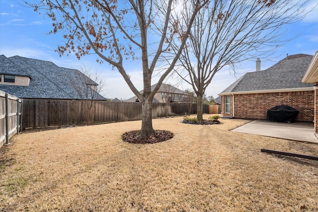 view of yard with a fenced backyard and a patio