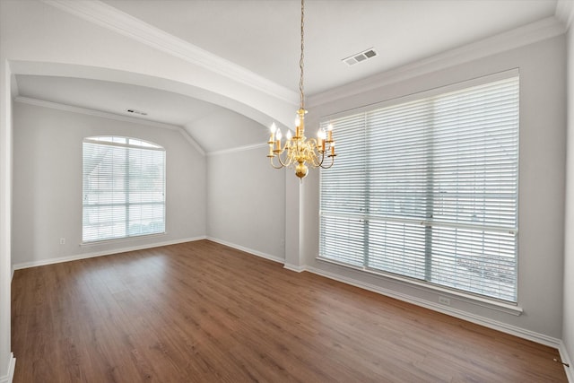 unfurnished room featuring a notable chandelier, visible vents, ornamental molding, wood finished floors, and baseboards